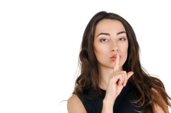 Young beautiful brunette woman has put forefinger to lips as sign of silence