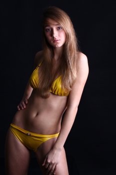 Young sexy woman in yellow bikini 
