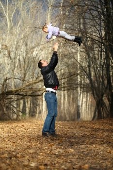 Father and little girl in autumn park