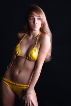 Young sexy woman in yellow bikini 
