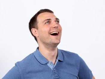 Portrait of a happy young man standing against white background 