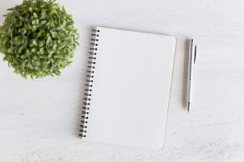 Flat lay photo of office desk on white background,empty notebook open on white wood table