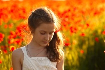 young  girl portrait at the poppies field
