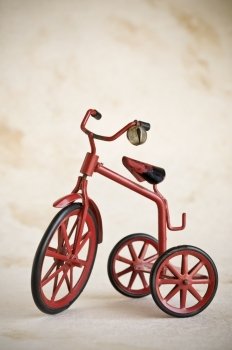 tiny red toy vintage metal tricycle