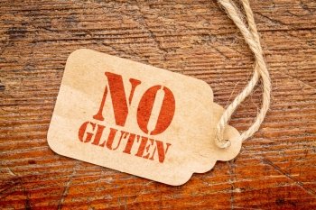 No gluten sign - a paper price tag against rustic red painted barn wood