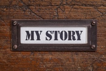 my story -  file cabinet label, bronze holder against grunge and scratched wood