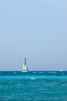 Small yacht with sail on Mediterranean Sea