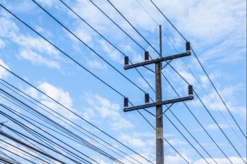high voltage equipment on an electric pole with blue sky background
