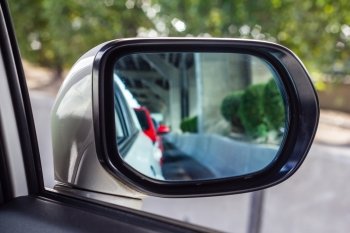 The mirror of the car with the road
