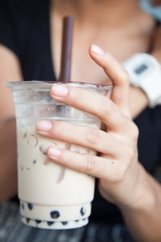 Handle Coffee Mug Hand holding a plastic cup containing coffee.