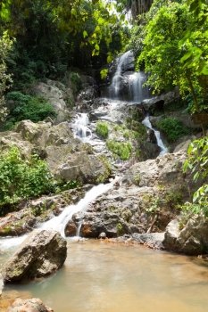 Water falling from a cliff. Water flowing down from the rocks of the waterfall. On Koh Samui