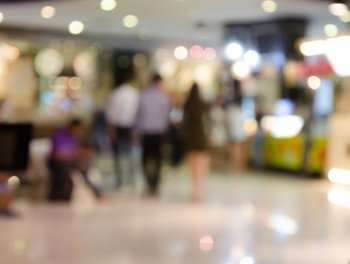 People shopping in department store. Defocused blur background.