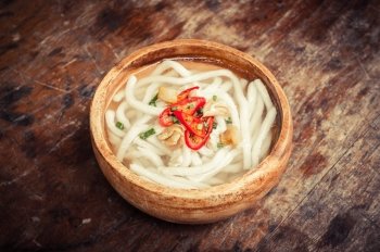 udon noodle in wood bowl on wooden floor