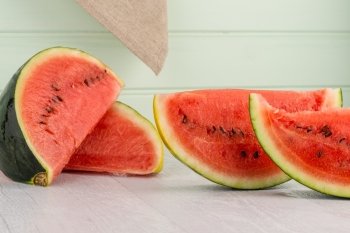 Watermelon slices on wooden vintage background.