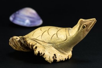 decorative marquetry wooden turtle on black background