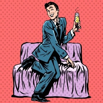 Playful man with a glass of champagne on the couch. Playful man with a glass of champagne on the couch. Humor Dating romance