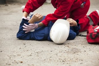 Paramedics providing first aid to an injured person