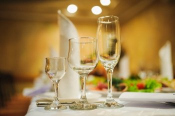 Banquet wedding table setting on evening reception awaiting guests. wineglass or glass Banquet wedding table setting