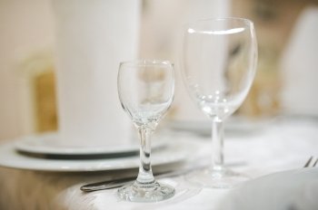 Banquet wedding table setting with plate and wineglass or glass. table setting with plate and wineglass or glass
