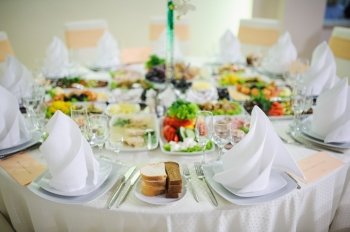 Banquet wedding table setting on evening reception awaiting guests. Banquet wedding table setting on evening reception