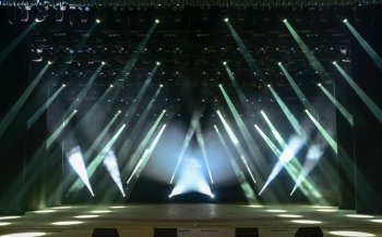Illuminated empty concert stage with smoke and rays of light