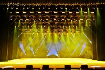 Illuminated empty concert stage with smoke and rays of light