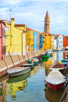 Color houses with boats on Burano island near Venice , Italy