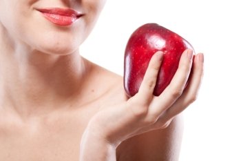 Portrait of smiling woman holding red apple isolated on white