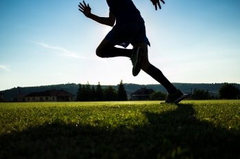 Silhouette of an athlete running on a stadium