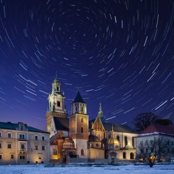 Star trails over the Royal Cathedral on Wawel Hill within the grounds of Wawel Castle in Krakow in Poland. The cathedral features the Baroque style chapel of the Vasa family and the renaissance Zyguntowska Chapel whose dome is covered in pure gold provide by Queen Anna Jagiellonka in 1591.