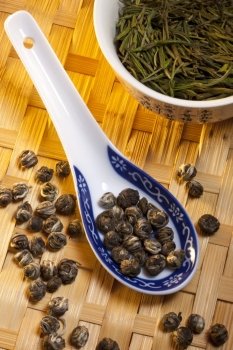 Chinese Jasmine Pearl Tea (on spoon) and Anji Bai Cha Green Tea (in bowl).
