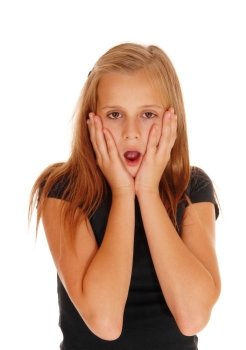 A very scared looking young girl with her mouth open and her hands onher face in portrait, isolated for white background.
