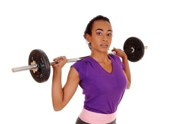A slim pretty african american woman lifting weight, standing isolatedfor white background with the weight behind her head.