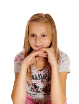 A blond young girl sitting on a chair with her hands under her chin isolatedfor white background