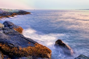 Long exposure image of sunset on a rocky shore. Sunset on a rocky shore.