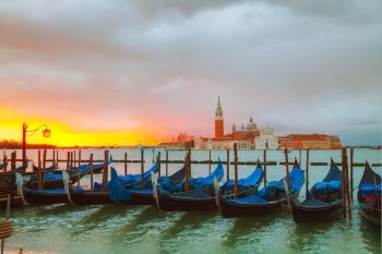 Gondolas floating in the Grand Canal at sunrise