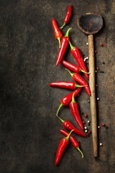 Vibrant red mexican hot chilli pepper on old background