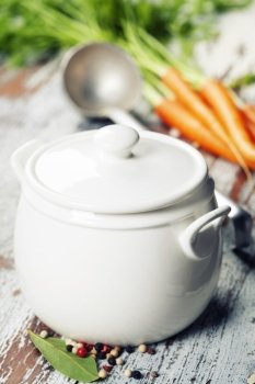 Ingredients for vegetable (vegetarian) soup and cooking pot on vintage background