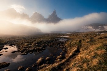 Sunny and foggy morning at the lake, Passo Rolle, Dolomites Alps, Italy