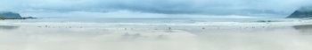Summer cloudy view of the beach with white sand in Ramberg (Norway, Lofoten). Panorama.