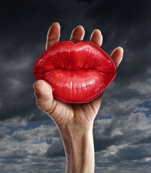 Romantic love possession in a passion relationship concept with a male hand holding red ruby red female lips as a metaphor for learning to let go emotional prison and psychological confinement.