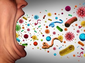 Human disease spreading as microscopic pathogens are being spread through an open mouth that is coughing or sneezing transmitting illness and contagious virus or bacteria as dangerous airborne germs.