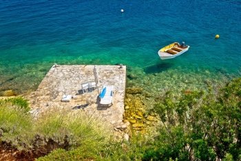 Lonely idyllic island beach and wooden boat aerial view, Dalmatia, Croatia