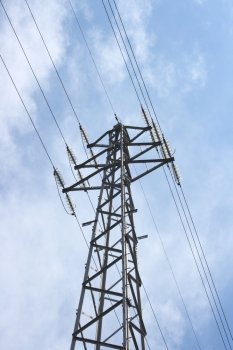 large transmission power pole, with blue sky background