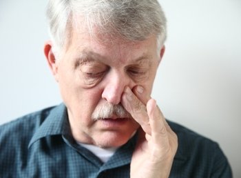 mature man with congestion from a cold or allergies