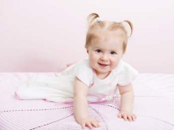 Portrait of beautiful baby girl on a light background