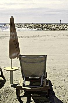 Beach Umbrella and Sun Bed in the Low Season, Vintage Style Toned Picture