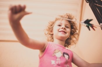Little happy girl having fun, tinted photo
