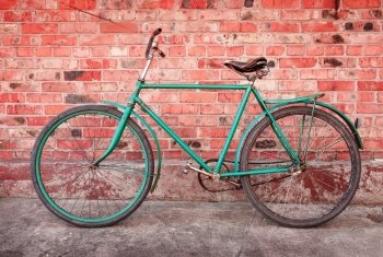 Old retro bicycle against brick wall 