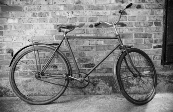 Old retro bicycle against brick wal, bw photol